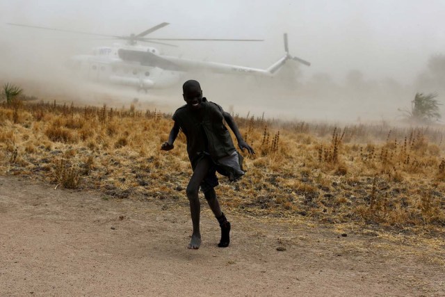 A boy moves away as a United Nations World Food Programme (WFP) helicopter lands in Rubkuai village, Unity State, northern South Sudan, February 18, 2017. Picture taken February 18, 2017. REUTERS/Siegfried Modola TPX IMAGES OF THE DAY