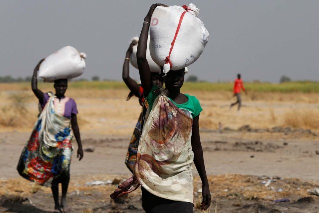 Women carry sacks of food in Nimini village, Unity State, northern South Sudan, February 8, 2017. Picture taken on February 8, 2017. REUTERS/Siegfried Modola