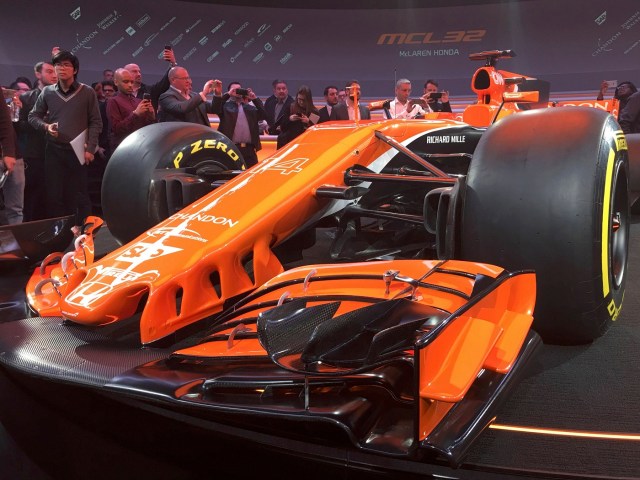 Journalists use their mobile phones to photograph McLaren's new MCL32 Formula One car at its launch in Woking, Britain, February 24, 2017. REUTER/Alan Baldwin