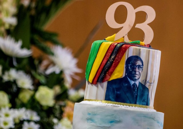 A picture taken on February 21, 2017 shows a cake bearing a portrait of Zimbabwe's President Robert Mugabe during a private ceremony to celebrate Mugabe's 93rd birthday in Harare.  Mugabe, the world's oldest national ruler, turned 93, using a long and occasionally rambling interview to vow to remain in power despite growing signs of frailty. / AFP PHOTO / Jekesai NJIKIZANA