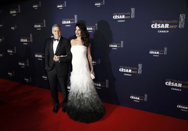 Actor George Clooney and his wife Amal pose as they arrive at the 42nd Cesar Awards ceremony in Paris, France, February 24, 2017.  REUTERS/Gonzalo Fuentes  TPX IMAGES OF THE DAY