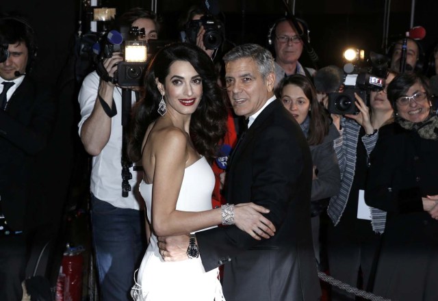 Actor George Clooney and his wife Amal pose as they arrive at the 42nd Cesar Awards ceremony in Paris, France, February 24, 2017.  REUTERS/Gonzalo Fuentes  TPX IMAGES OF THE DAY