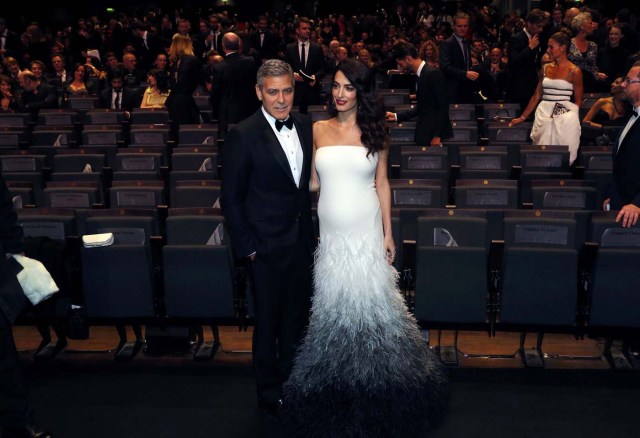 Actor George Clooney and his wife Amal pose as they arrive at the 42nd Cesar Awards ceremony in Paris, France, February 24, 2017.  REUTERS/Philippe Wojazer