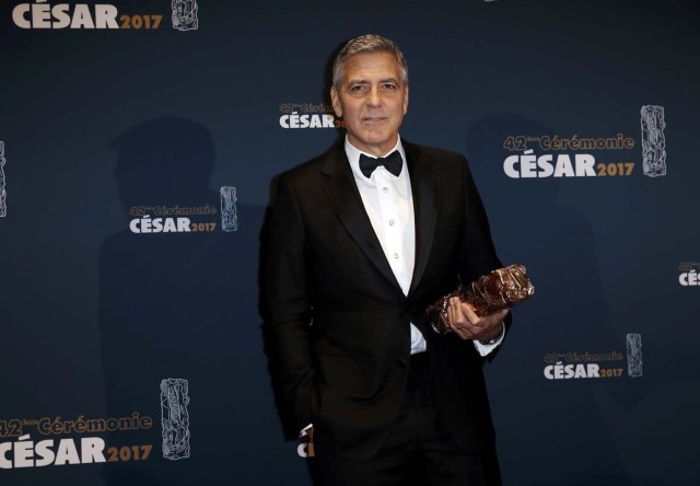 Actor George Clooney holds his trophy during a photocall after receiving an Honorary Cesar Award at the 42nd Cesar Awards ceremony in Paris, France, February 24, 2017.  REUTERS/Gonzalo Fuentes