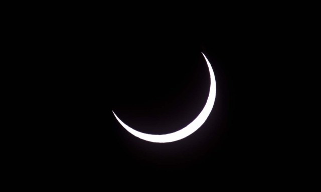 Picture taken on February 26, 2017 showing the moon moving to cover the sun for an annular solar eclipse, as seen from the Estancia El Muster, near Sarmiento, Chubut province, 1600 km south of Buenos Aires, Argentina, on February 26, 2017. Stargazers applauded as they were plunged into darkness Sunday when the moon passed in front of the sun in a spectacular "ring of fire" eclipse. / AFP PHOTO / ALEJANDRO PAGNI