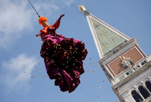 A woman dressed as an "angel" descends on Saint Mark's Square during the Venice Carnival, Italy February 19, 2017. REUTERS/Alessandro Bianchi TPX IMAGES OF THE DAY