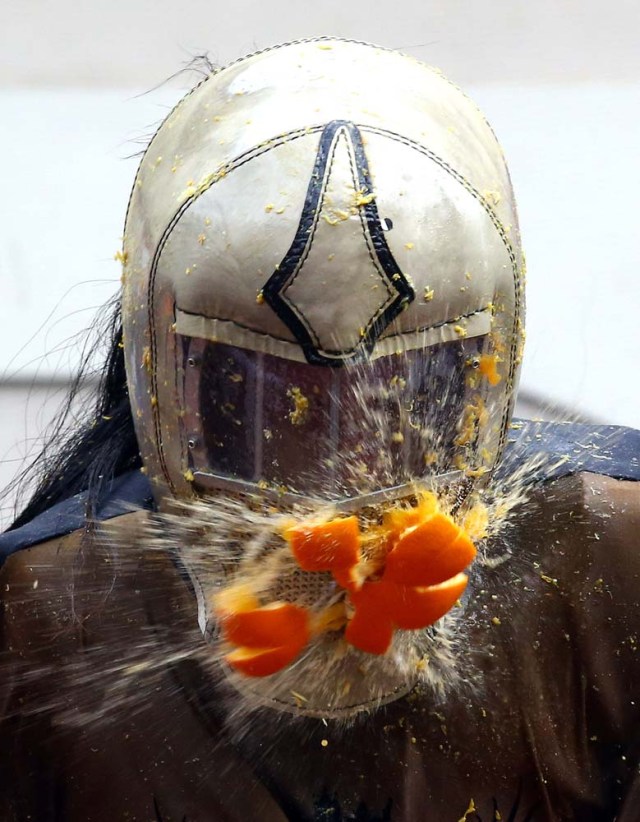 A member of a rival team is hit by an orange during an annual carnival orange battle in the northern Italian town of Ivrea February 26, 2017.  REUTERS/Stefano Rellandini