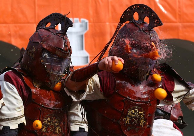 A member of a rival team is hit by an orange during an annual carnival orange battle in the northern Italian town of Ivrea February 26, 2017.  REUTERS/Stefano Rellandini