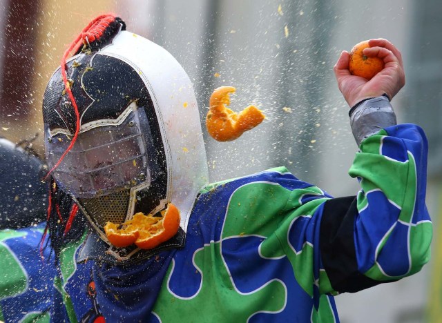A member of a rival team is hit by an orange during an annual carnival orange battle in the northern Italian town of Ivrea February 26, 2017.  REUTERS/Stefano Rellandini