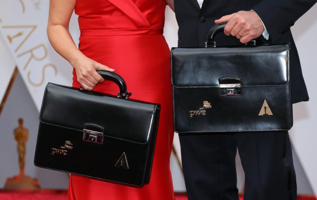 89th Academy Awards - Oscars Red Carpet Arrivals - Hollywood, California, U.S. - 26/02/17 - Martha Ruiz (L) and Brian Cullinan of PricewaterhouseCoopers hold briefcases containing the winners on the red carpet. REUTERS/Mike Blake