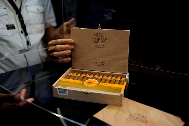 People open a box of cigars on display at the 19th Habanos Festival in Havana, Cuba, February 27, 2017. REUTERS/Alexandre Meneghini