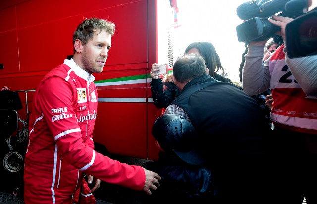 Ferrari's German driver Sebastian Vettel walks at the Circuit de Catalunya on February 27, 2017 in Montmelo on the outskirts of Barcelona during the first day of the first week of tests for the Formula One Grand Prix season.  / AFP PHOTO / JOSE JORDAN