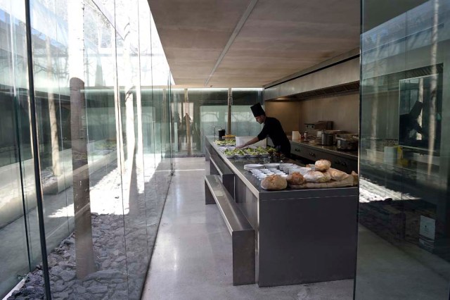 A picture taken in Olot on March 2, 2017 shows a chef in the kitchen of the restaurant "les Cols" designed by RCR architects, formed by Spanish architects, Rafael Aranda, Carme Pigem and Ramon Vialta who won yesterday the prestigious Pritzker Prize for modern works. The choice was seen as a move away from the celebrity architects that have dominated the field in favour of the homegrown vision of a trio of professionals who have worked together for 30 years in their hometown of Olot in Catalonia. / AFP PHOTO / LLUIS GENE