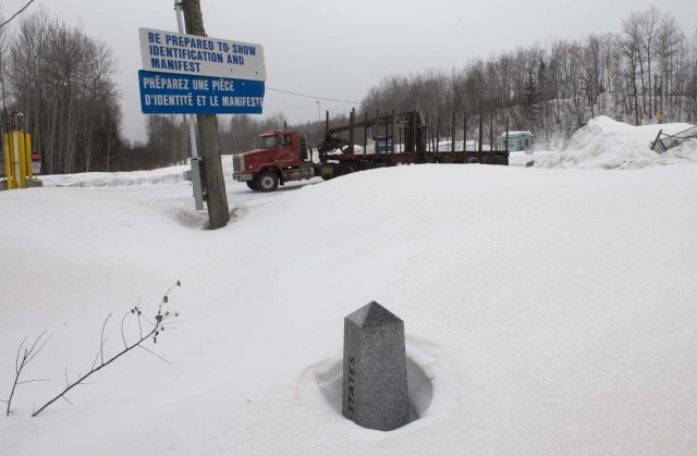 A boundary marker marks the US/Canada border March 2, 2017, in Estcourt, Maine. On the one side of the marker is Estcourt and one the other side is Pohenegamook, Quebec. / AFP PHOTO / Don EMMERT