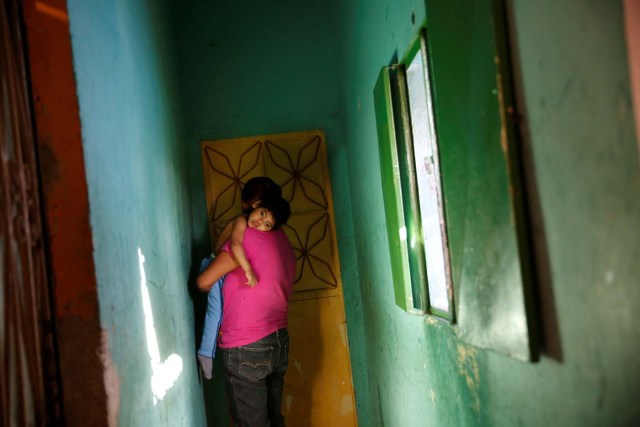 Isabel Buelvas, carries her grandson Kaleth Heredia, 2, a neurological patient being treated with anticonvulsants, at their house in Caracas, Venezuela January 30, 2017. REUTERS/Carlos Garcia Rawlins   SEARCH "EPILEPSY CARACAS" FOR THIS STORY. SEARCH "WIDER IMAGE" FOR ALL STORIES.