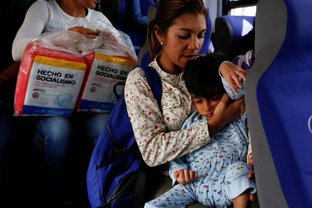Norymar Torres carries her son Leonardo Colmenares, 6, neurological patient being treated with anticonvulsants, while they travel on public transport in Caracas, Venezuela January 18, 2017. REUTERS/Carlos Garcia Rawlins   SEARCH "EPILEPSY CARACAS" FOR THIS STORY. SEARCH "WIDER IMAGE" FOR ALL STORIES.