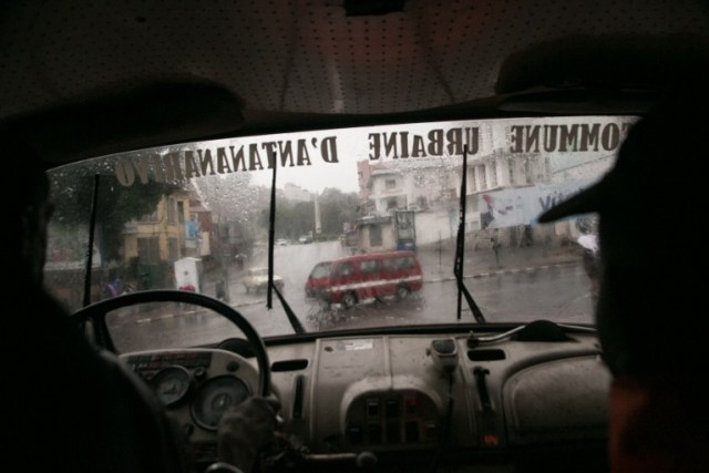Malagasy firefighters drive around for emergency calls during tropical cyclone Enawo in Antananarivo, Madagascar, on March 8, 2017. At least four people have been killed by tropical cyclone Enawo in Madagascar, the prime minister said on March 8, 2017, as the storm tracked towards the capital Antananarivo threatening severe flooding. / AFP PHOTO / RIJASOLO