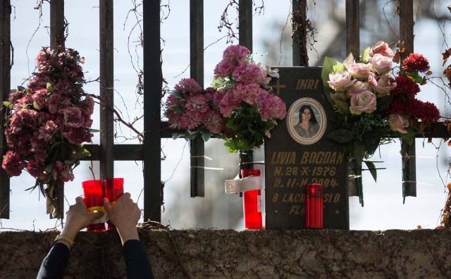 A man places candles at the same spot a train was bombed in the 2004 Madrid train bombings, at a memorial site for the victims of the bombings, near Atocha station in Madrid, Spain, March 11, 2017. REUTERS/Sergio Perez