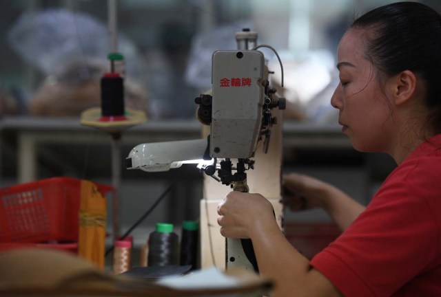 (FILES) This file photo taken on September 14, 2016 shows a worker at the Huajian shoe factory, where about 100,000 pairs of Ivanka Trump-branded shoes have been made over the years amongst other brands, in Dongguan in south China's Guangdong province. In his January inauguration speech, US President Donald Trump made a seemingly straightforward pledge: "We will follow two simple rules: buy American and hire American." His daughter is the exception: even as he spoke, at least eight shipments of Ivanka Trump-branded shoes, bags and clothes -- more than 53.5 tonnes -- were steaming towards American ports from China, according to US Customs bills of lading examined by AFP. / AFP PHOTO / Greg Baker / TO GO WITH China-US-politics-economy-trade-Trump, FOCUS by Ben DOOLEY