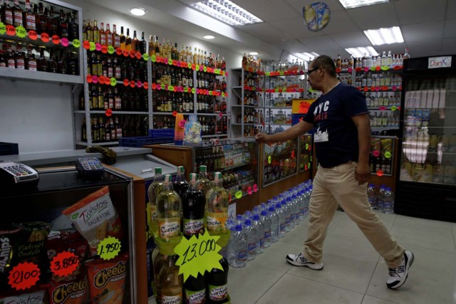 A man walks inside a liquor store in downtown Caracas, Venezuela March 10, 2017. REUTERS/Marco Bello