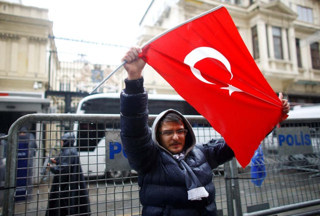A demonstrator holds a Turkish flag during a protest in front of the Dutch Consulate in Istanbul, Turkey, March 12, 2017. REUTERS/Osman Orsal