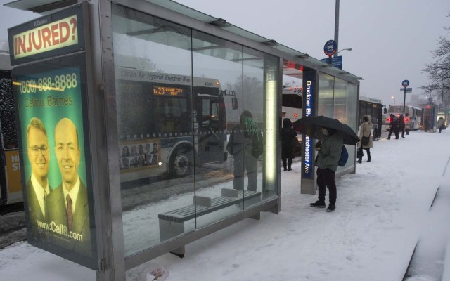 Passengers wait to board buses in the Bronx Borough March 14, 2017 in New York. Winter Storm Stella dumped snow and sleet Tuesday across the northeastern United States where thousands of flights were canceled and schools closed, but appeared less severe than initially forecast. After daybreak the National Weather Service (NWS) revised down its predicted snow accumulation for the city of New York, saying that the storm had moved across the coast. / AFP PHOTO / DON EMMERT