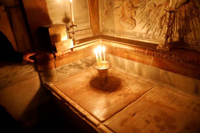 Candles are placed atop the newly restored tomb, which according to Christian belief is where Jesus's body was anointed and buried, inside the newly restored Edicule, the ancient structure housing the tomb, at the Church of the Holy Sepulchre in Jerusalem's Old City March 20, 2017. REUTERS/Ronen Zvulun