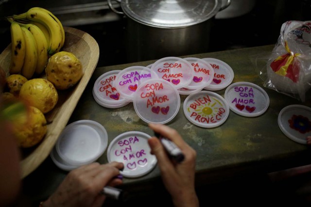 Lids with messages that read "soup with love" are seen at the home kitchen of a volunteer of Make The Difference (Haz La Diferencia) charity initiative, in Caracas, Venezuela March 5, 2017. Picture taken March 5, 2017. REUTERS/Marco Bello