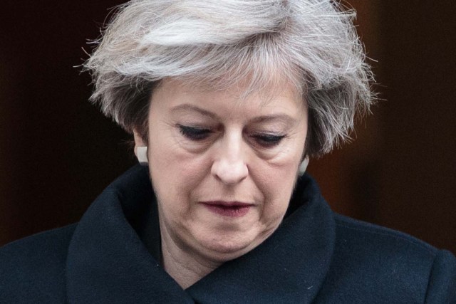 British Prime Minister Theresa May leaves 10 Downing Street in central London on March 23, 2017. Britain's parliament reopened on Thursday with a minute's silence in a gesture of defiance a day after an attacker sowed terror in the heart of Westminster, killing three people before being shot dead. Sombre-looking lawmakers in a packed House of Commons chamber bowed their heads and police officers also marked the silence standing outside the headquarters of London's Metropolitan Police nearby. / AFP PHOTO / POOL / Jack Taylor