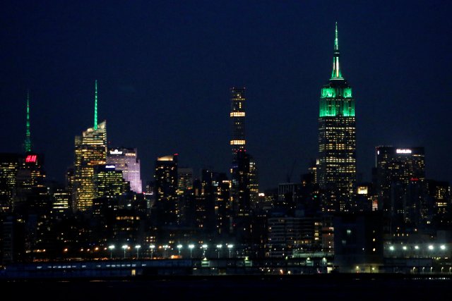 4 Times Square, The Bank of America Tower and the Empire State Building have their spires lit green for St. Patrick's day in Manhattan, New York, U.S., March 17, 2017.  REUTERS/Andrew Kelly