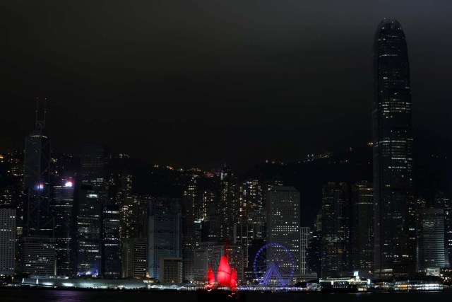 A tourist junk sails past as most of the lights in buildings in the financial Central District are switched off during Earth Hour in Hong Kong, China March 25, 2017. REUTERS/Bobby Yip