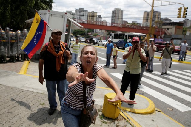A pro-government supporter shouts slogans to opposition supporters and deputies of Venezuelan coalition of opposition parties (MUD) during a protest outside the Supreme Court in Caracas