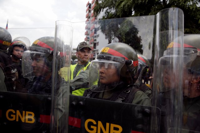 Venezuelan National Guard members stand guard during a protest of opposition supporters and deputies of Venezuelan coalition of opposition parties (MUD) outside the Supreme Court in Caracas