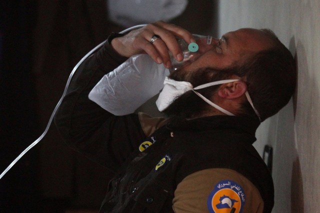 A civil defence member breathes through an oxygen mask, after what rescue workers described as a suspected gas attack in the town of Khan Sheikhoun in rebel-held Idlib, Syria April 4, 2017. REUTERS/Ammar Abdullah TPX IMAGES OF THE DAY