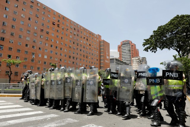 Security forces block a street using riot shields during an opposition rally in Caracas, Venezuela April 4, 2017. REUTERS/Carlos Garcia Rawlins