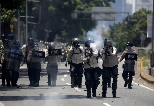 Riot police officers fires tear gas canister towards demonstrators during a rally in Caracas, Venezuela, April 8, 2017. REUTERS/Marco Bello