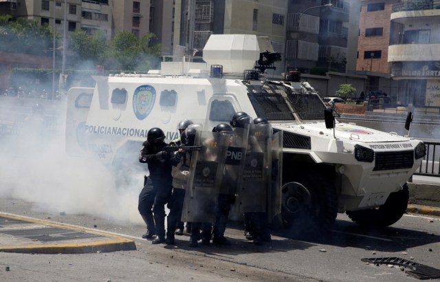 Riot police take position while clashing with demonstrators during a rally in Caracas, Venezuela, April 8, 2017. REUTERS/Carlos Garcia Rawlins