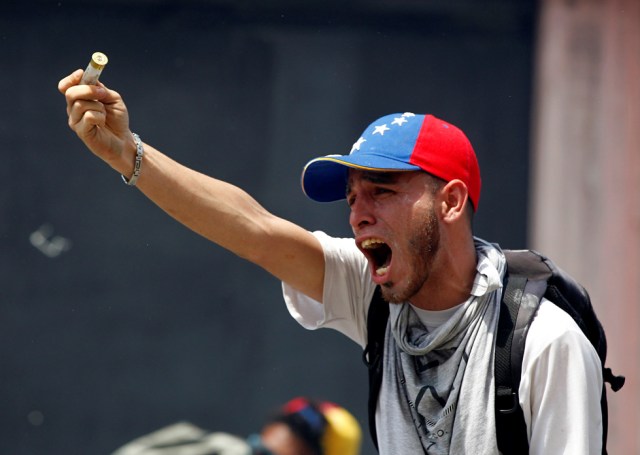 A demonstrator reacts while clashing with riot police during a rally in Caracas, Venezuela, April 8, 2017. REUTERS/Christian Veron