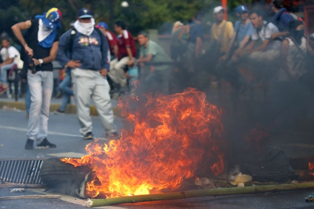 A fire barricade is seen on a street during an opposition rally in Caracas, Venezuela, April 8, 2017. REUTERS/Carlos Garcia Rawlins