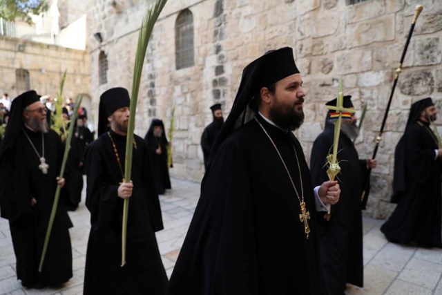 Members of the Orthodox Christian clergy take part in a Palm Sunday ceremony near the Church of the Holy Sepulchre in Jerusalem's Old City April 9, 2017. REUTERS/Ammar Awad