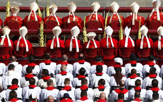 Cardinals and priests attend the Palm Sunday Mass led by Pope Francis  in Saint Peter's Square at the Vatican April 9, 2017. REUTERS/Tony Gentile