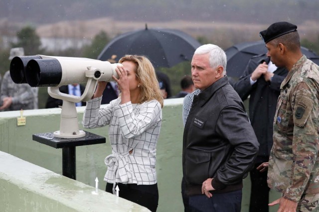 U.S. Vice President Mike Pence stands next to his daughter looking toward the north through a pair of binocular from an observation post inside the demilitarized zone separating the two Koreas, in Paju, South Korea, April 17, 2017.  REUTERS/Kim Hong-Ji