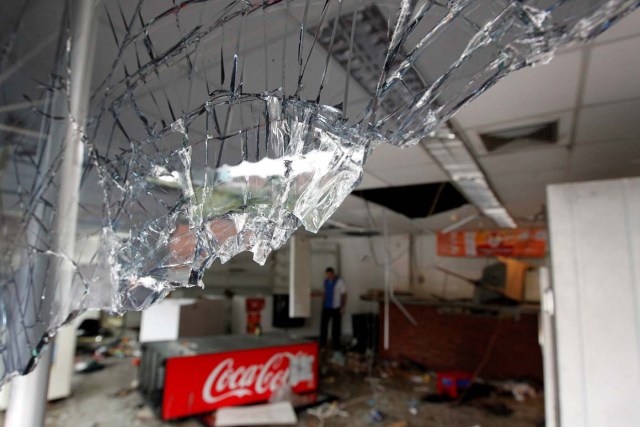 Broken glass is seen in a convenience store, after it was looted in Caracas, Venezuela April 21, 2017. REUTERS/Christian Veron