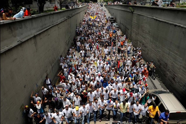 Demonstrators take part in a rally to honour victims of violence during a protest against Venezuela's President Nicolas Maduro's government in Caracas, Venezuela, April 22, 2017. REUTERS/Carlos Garcia Rawlins