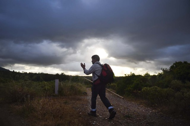 Carlos Gil starts his walk to Fatima with a backpack on his shoulders, in Cascais, outskirts of Lisbon, on May 5, 2017.  Carlos Gil is a payer-off of promises, at least that is the way the Roman Catholic refers to himself. But he is more commonly known as a rent-a-pilgrim. This 52-year-old Portuguese national takes on pilgrimages by proxy (in the name of others), especially Catholics unable to fulfil the journey because of sickness or too busy or lazy to undertake the week-long spiritual walk to the central Portuguese town of Fatima. He can be hired for an average cost of 2,500 euros. / AFP PHOTO / PATRICIA DE MELO MOREIRA / TO GO WITH AFP STORY BY BRIGITTE HAGEMANN