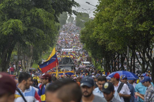 People march against President Nicolas Maduro in San Cristobal, Tachira State, Venezuela, on May 20, 2017. Venezuelan protesters and supporters of embattled President Nicolas Maduro take to the streets Saturday as a deadly political crisis plays out in a divided country on the verge of paralysis. / AFP PHOTO / LUIS ROBAYO