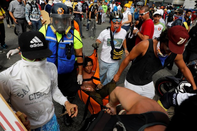 ATTENTION EDITORS - VISUAL COVERAGE OF SCENES OF INJURY OR DEATHAn injured opposition supporter is helped by others during a rally against President Nicolas Maduro in Caracas, Venezuela, May 3, 2017. REUTERS/Carlos Garcia Rawlins TEMPLATE OUT