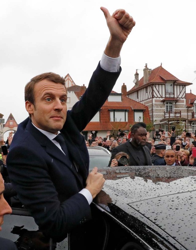 French presidential election candidate Emmanuel Macron, head of the political movement En Marche !, or Onwards ! gives thumb up to supporters as he leaves a polling station after voting in the the second round of 2017 French presidential election, in Le Touquet, France, May 7, 2017. REUTERS/Philippe Wojazer      TPX IMAGES OF THE DAY