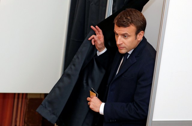 French presidential election candidate Emmanuel Macron, head of the political movement En Marche !, or Onwards ! leaves a pooling booth as he prepares to vote at a polling station during the the second round of 2017 French presidential election, in Le Touquet, France, May 7, 2017. REUTERS/Philippe Wojazer