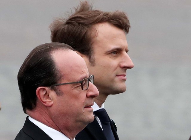 Outgoing French President Francois Hollande (L) and President-elect Emmanuel Macron attend a ceremony to mark the end of World War II at the Tomb of the Unknown Soldier at the Arc de Triomphe in Paris, France, May 8, 2017. REUTERS/Benoit Tessier TPX IMAGES OF THE DAY